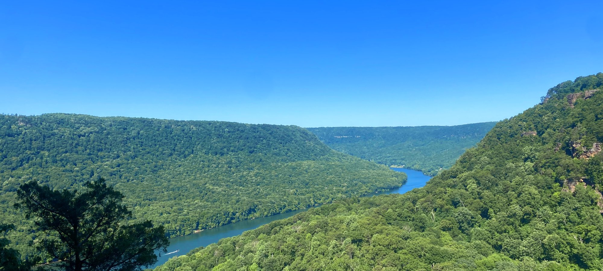 overlook of the river weaving between the green mountains in the distance