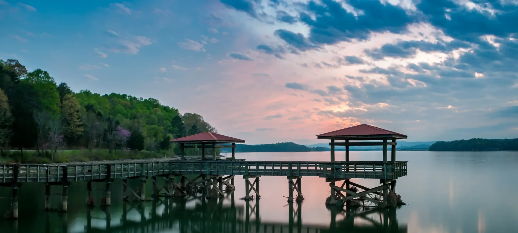 A golden sunset reflecting over the lake at Booker T. Washington State Park.