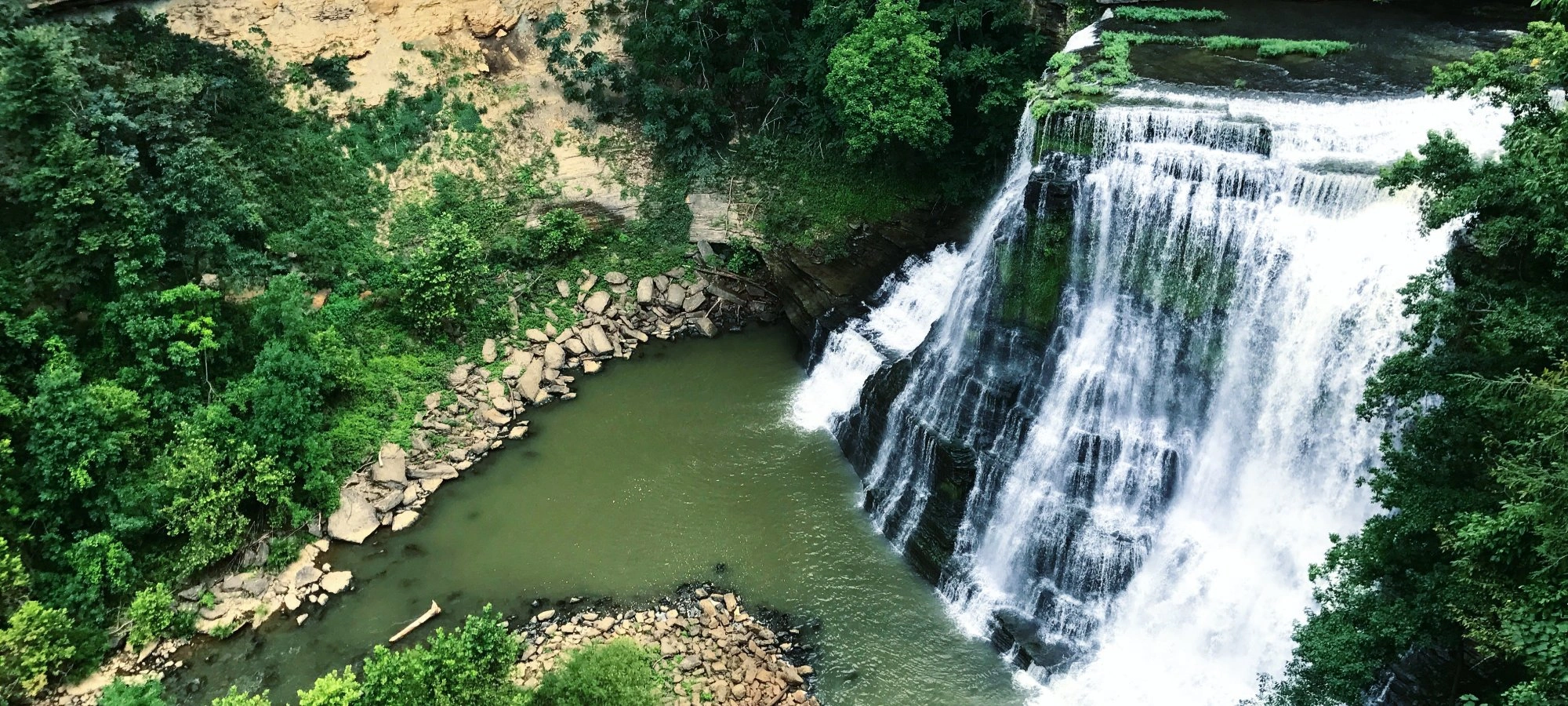 The upper waterfall at Burgess Falls State Park, cascading down rocky cliffs.