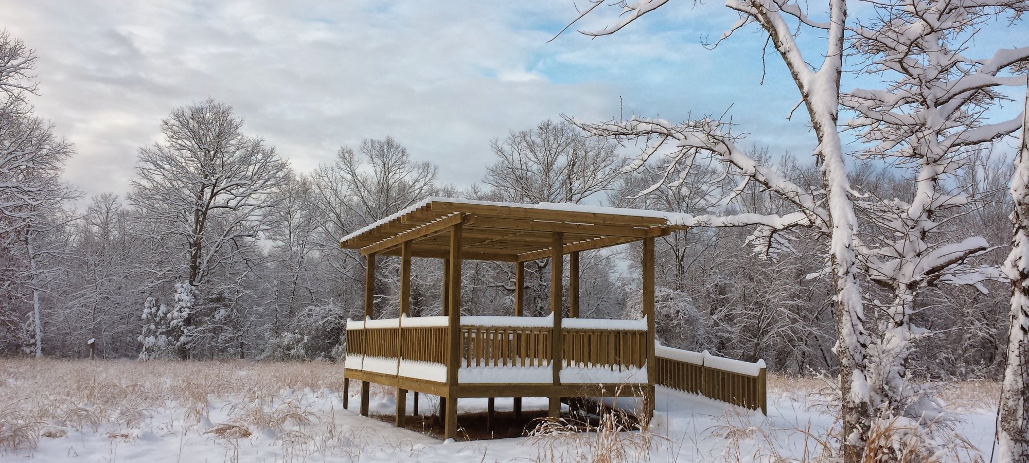 Wooden observation platform covered in snow