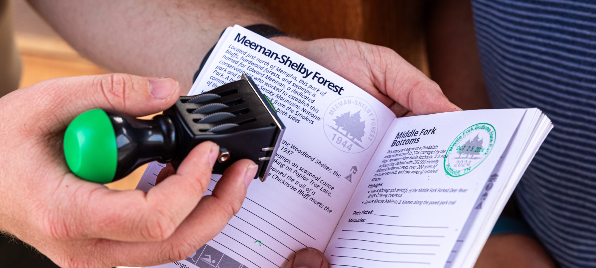 A person holds a booklet open to a page titled 