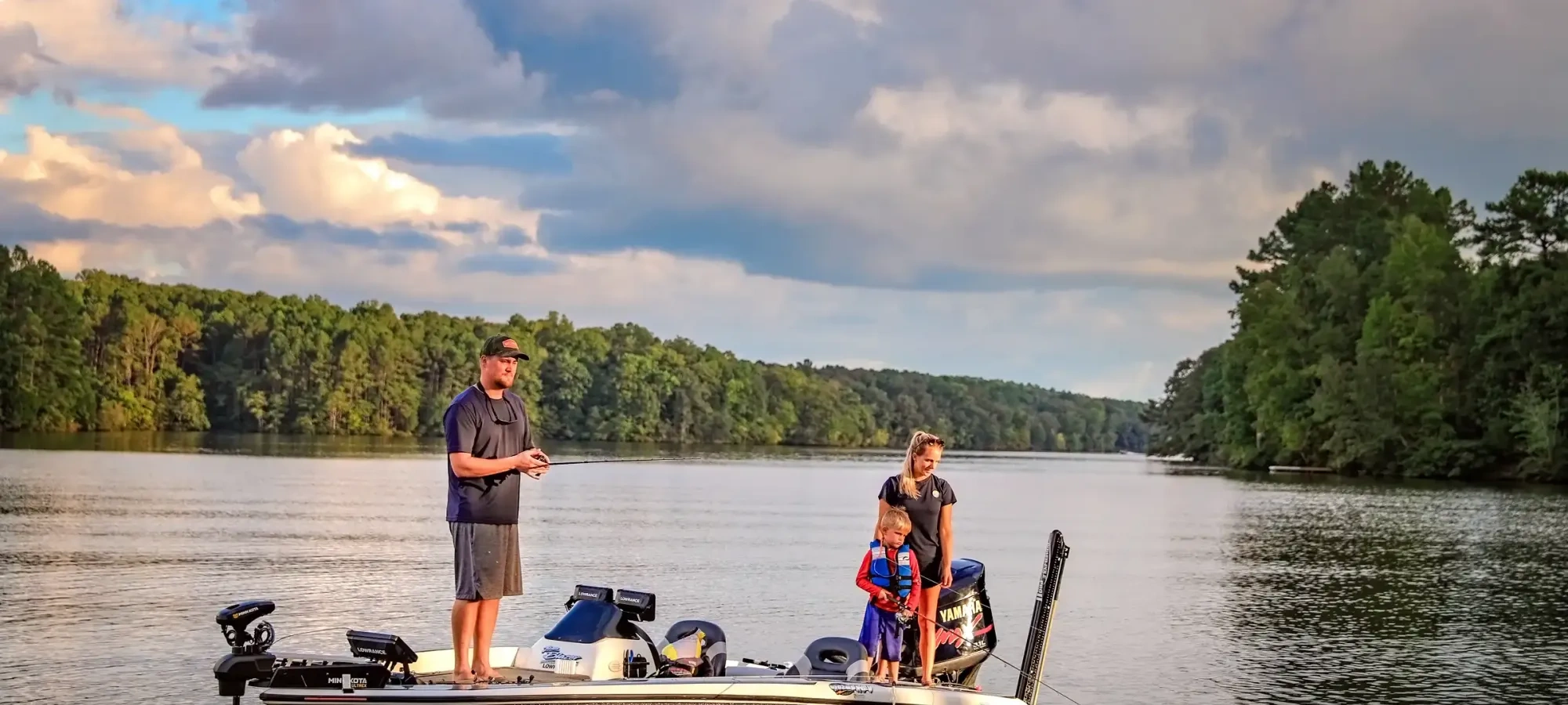 Family fishing from a dock at the lake.