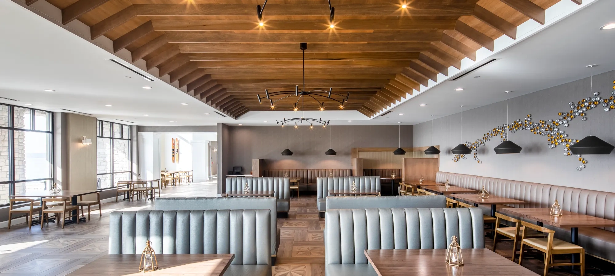 inside restaurant with booth seats in the middle and chairs with tables on the sides