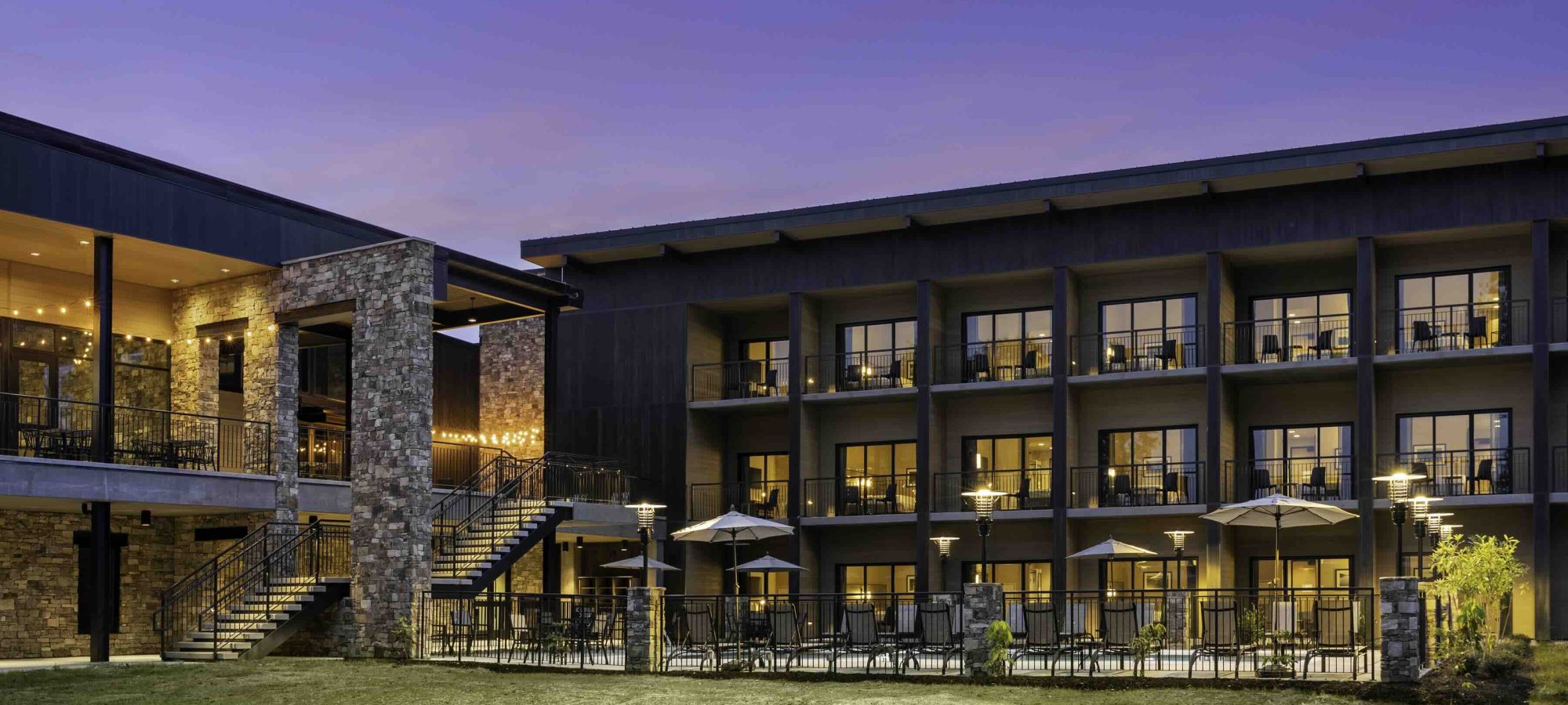 view of lodge at night with lights turned on