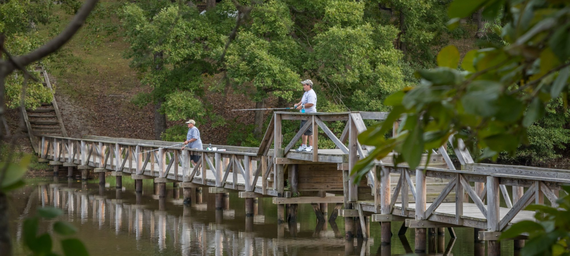 two guys fishing on the pedestrian bridge