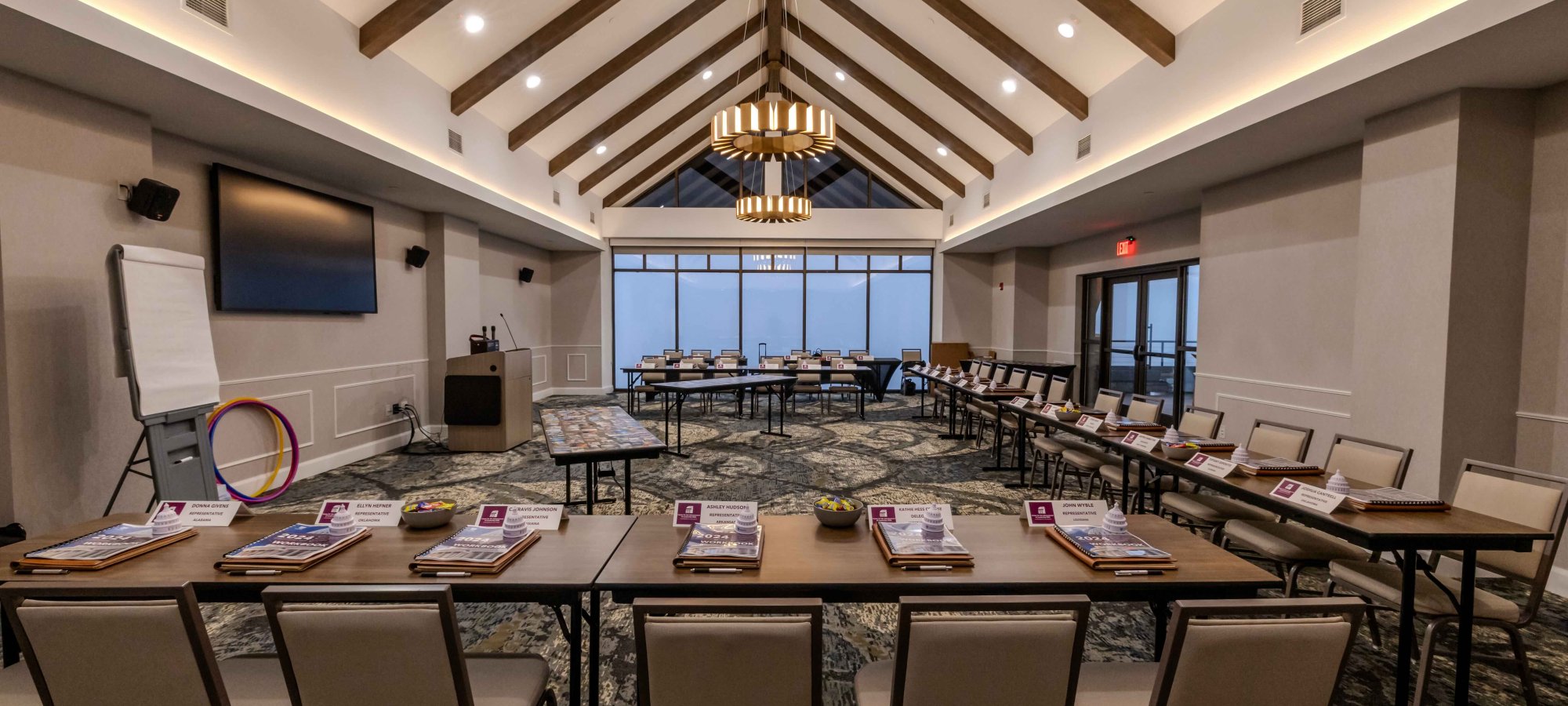 Conference room setup with chairs, tables, and presentation equipment.