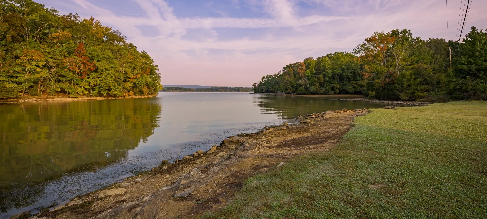 The shoreline of a lake at sunset