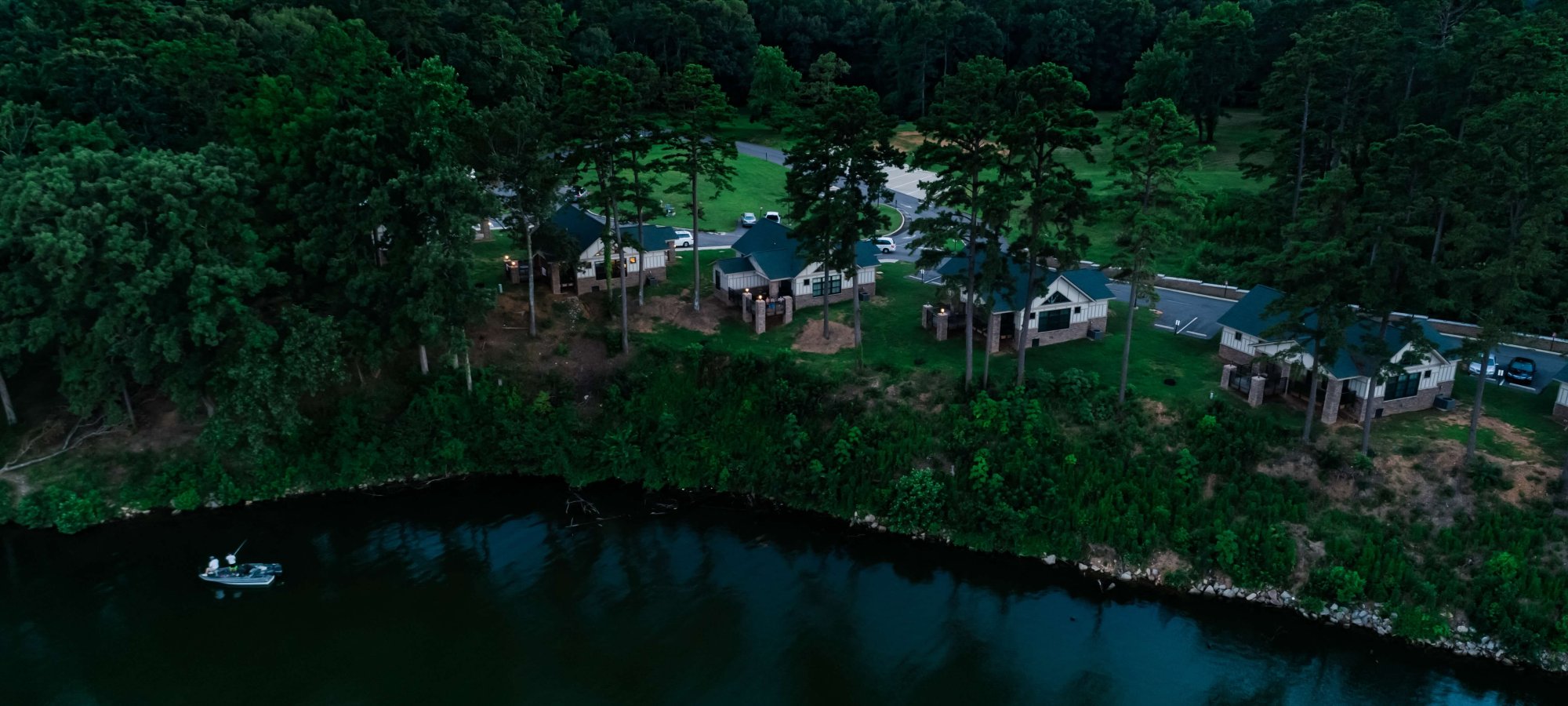 Aerial view of a lakeside residential area at dusk.