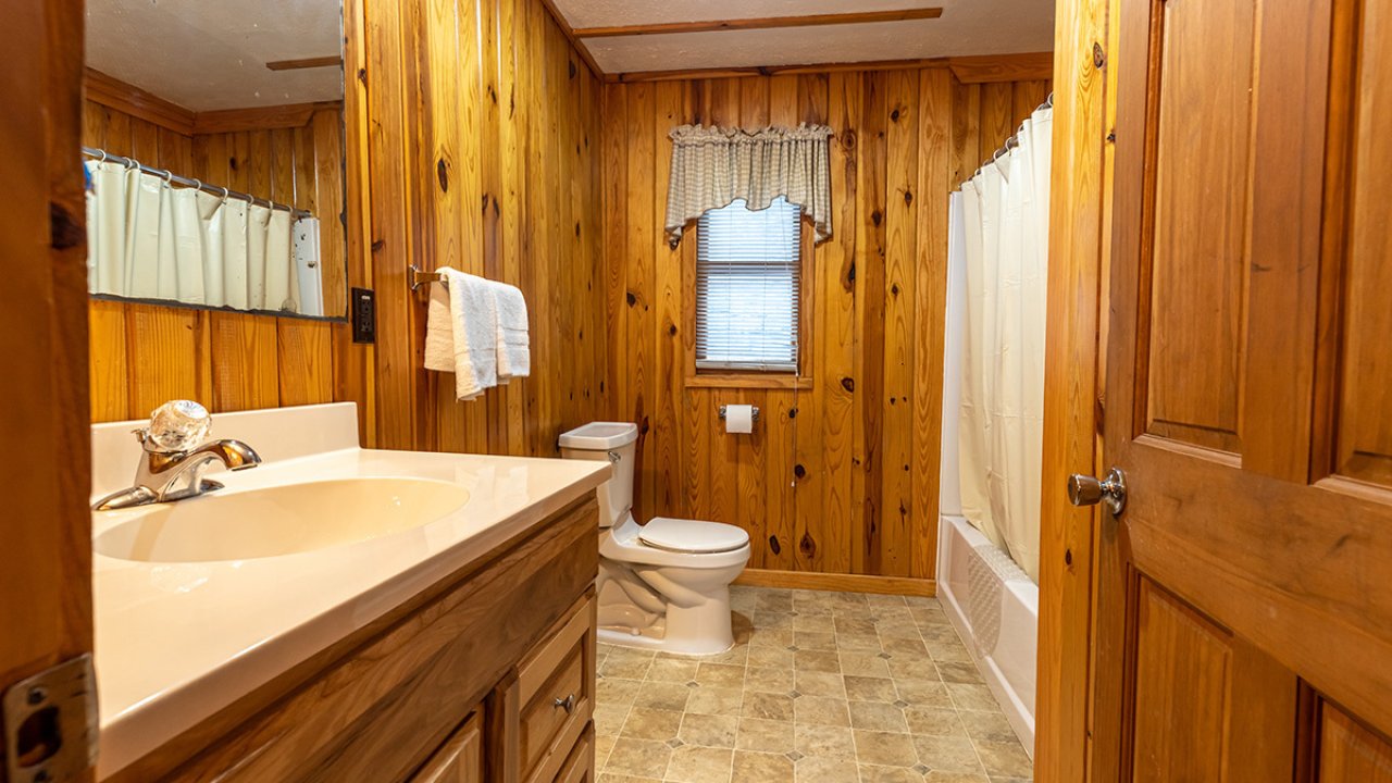 Wooden bathroom, well lit, cabin feel 