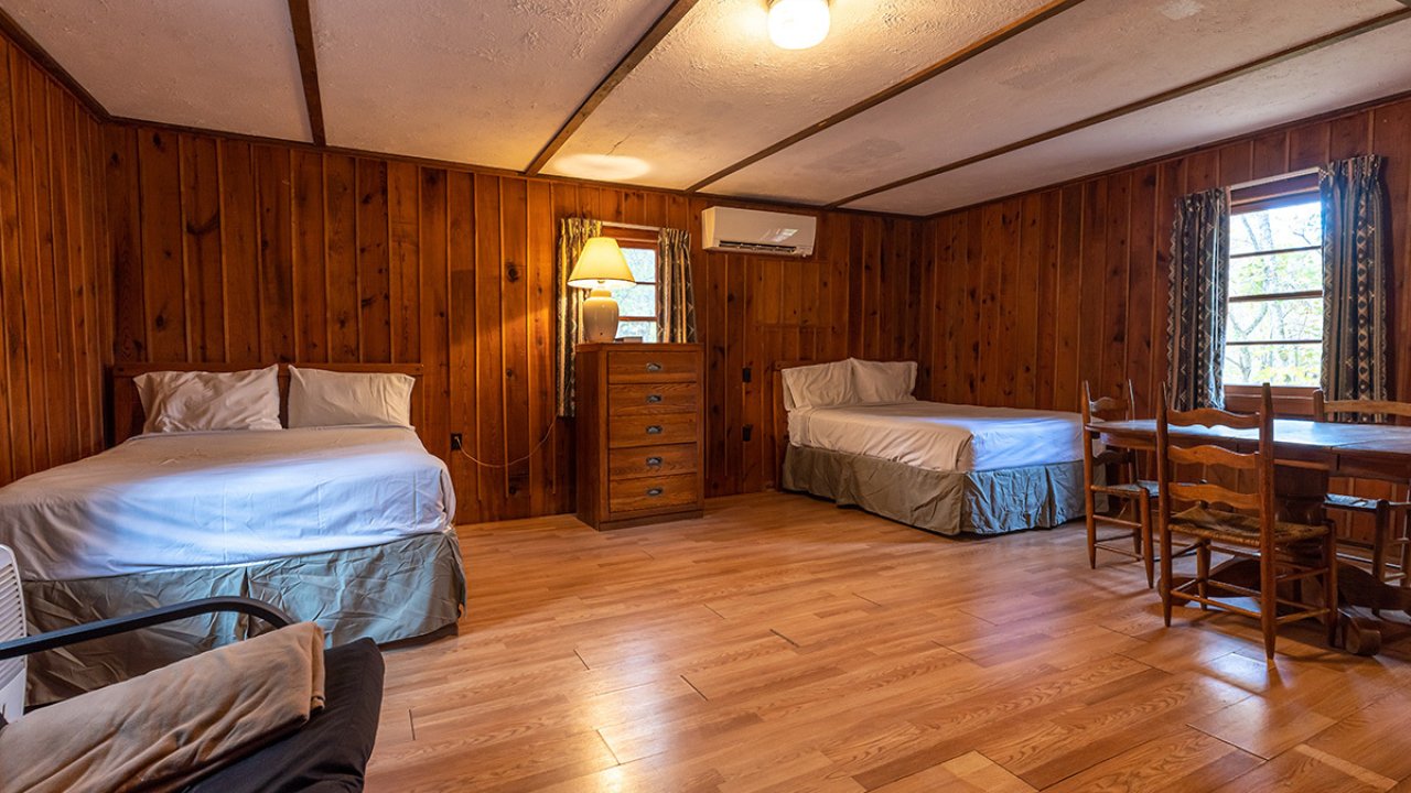 Two bedroom inside a cabin with clean, well lit floors