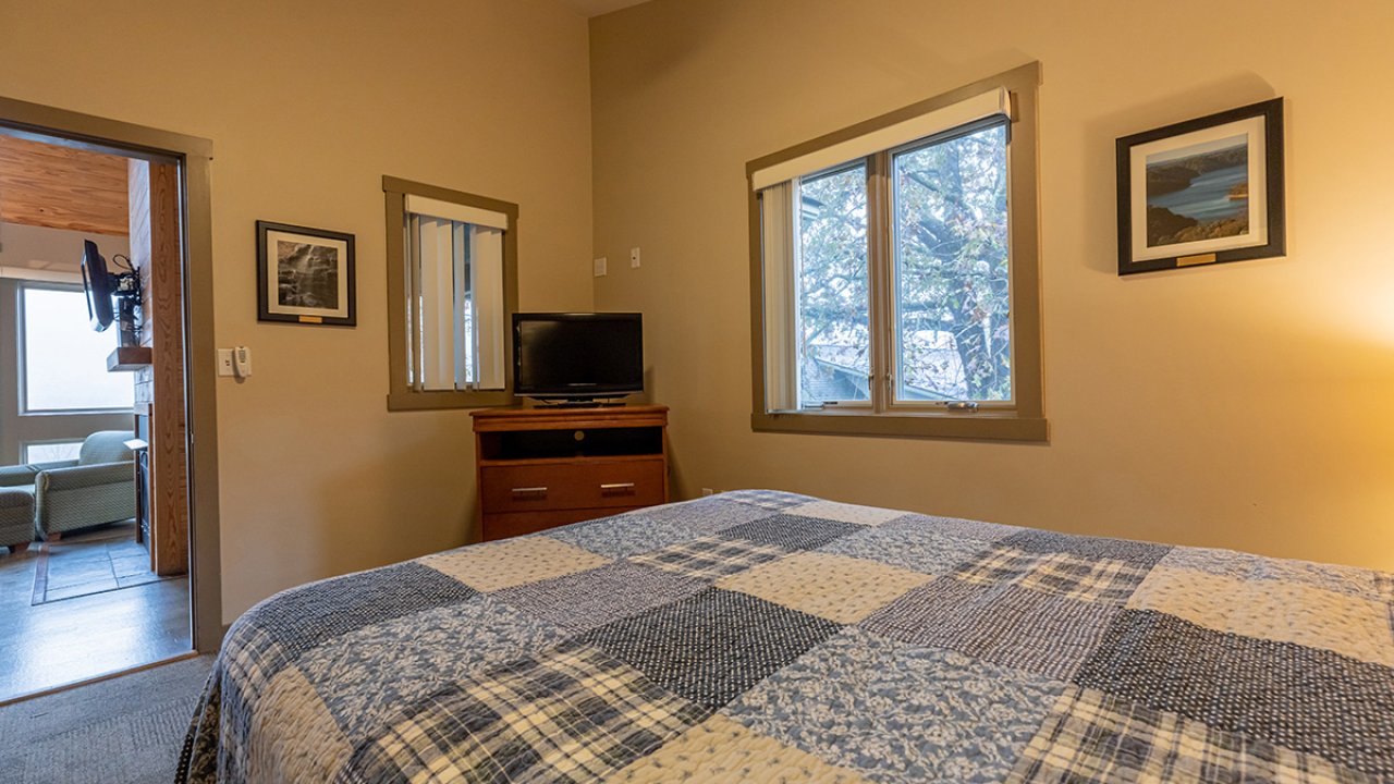 cabin bedroom with quilted queen bed