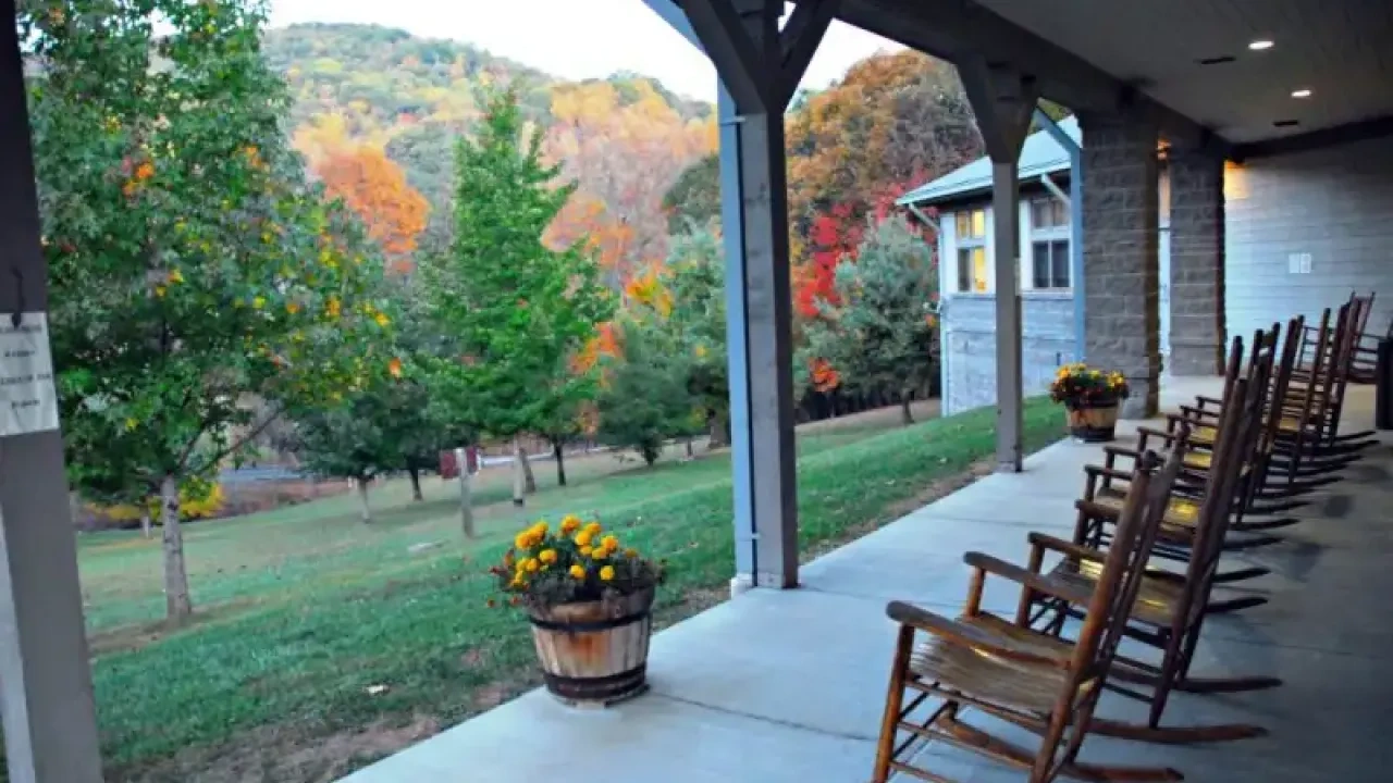 Front view of Roan Mountain conference center showing large windows and landscaped grounds.