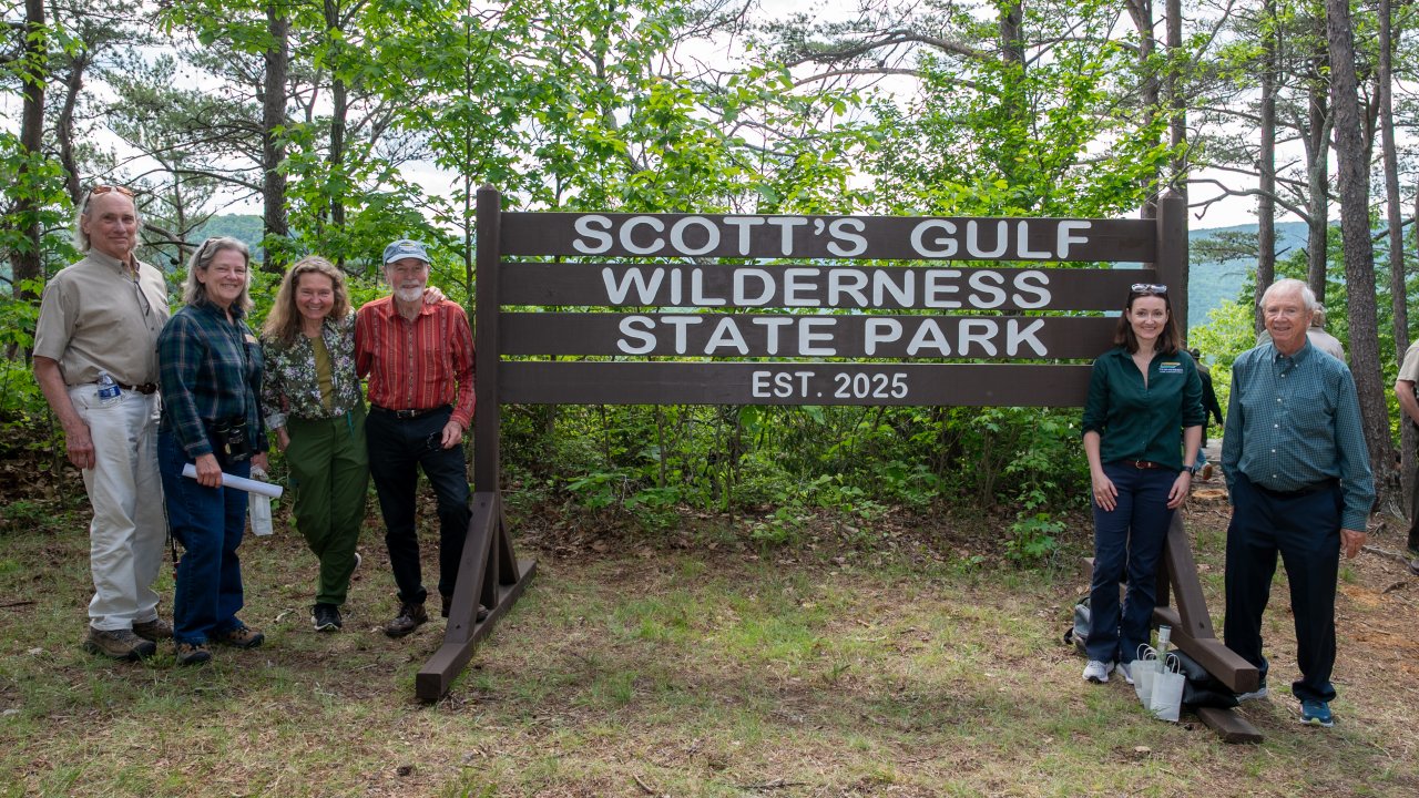 group of people standing next to sign that says Scotts gulf wilderness State Park