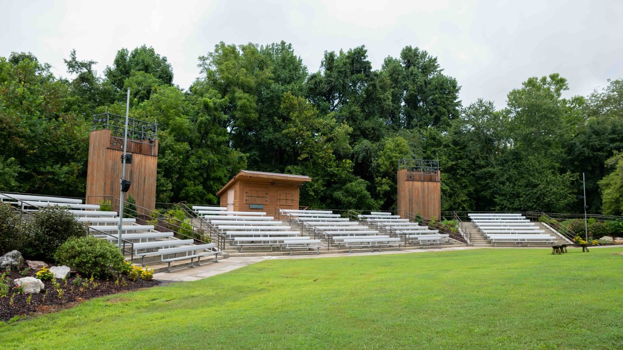 Amphitheater with several rows of metal bleachers for seating.