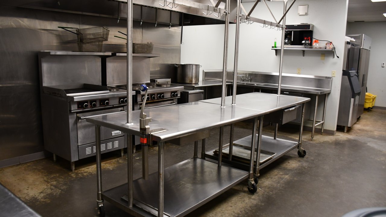 Commercial kitchen with stainless steel appliances and counters.
