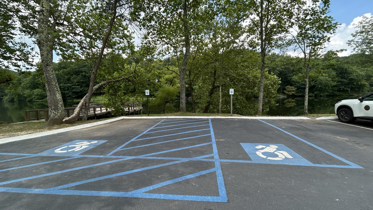 Accessible parking spaces surrounded by trees.