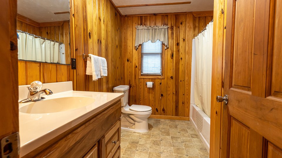 Wooden bathroom, well lit, cabin feel 