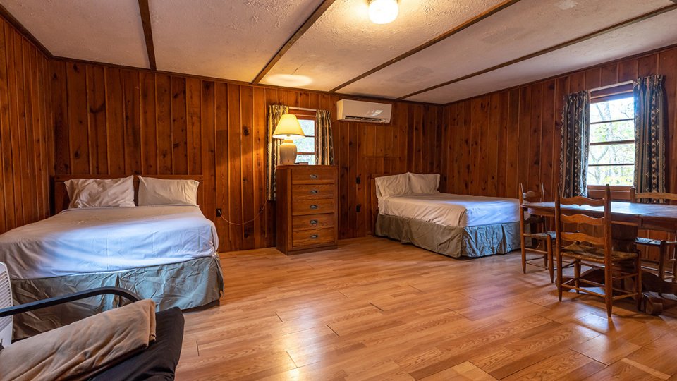 Two bedroom inside a cabin with clean, well lit floors
