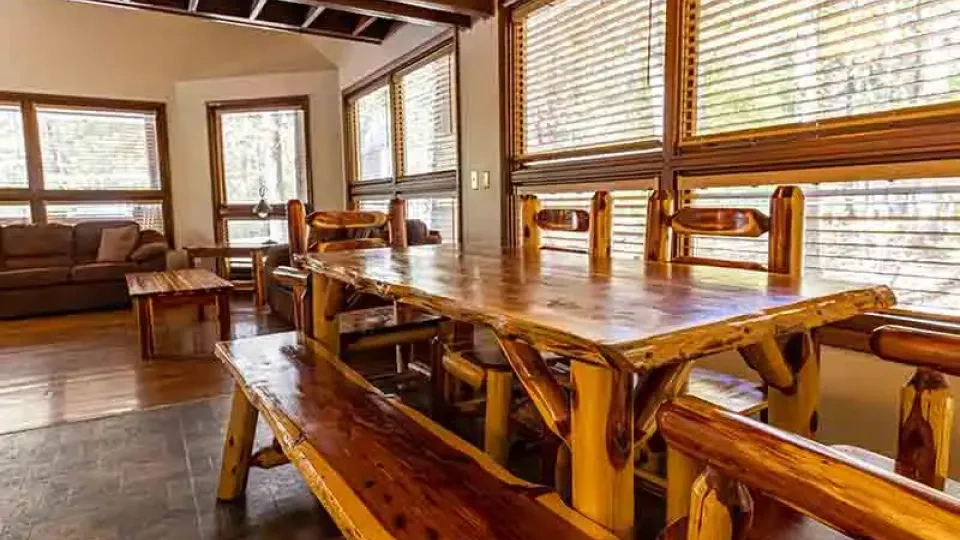 Cabin interior with dining table set near a window.