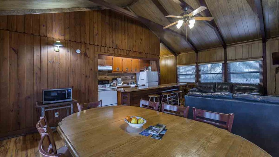 dining room with wooden chairs and table, with a microwave on top of cabinet