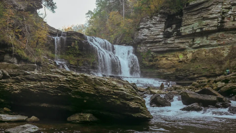 Waterfall surrounded by rocks that are walkable
