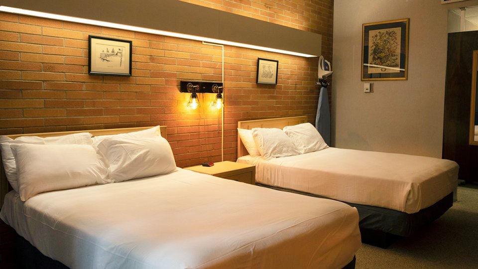 bedroom with two beds and soft overhead lighting