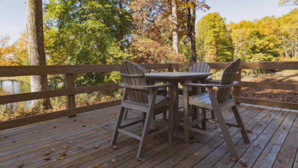 wooden chairs on deck near water