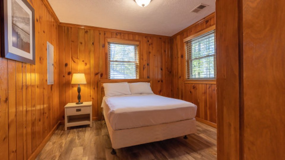 twin bed in wooden walled room