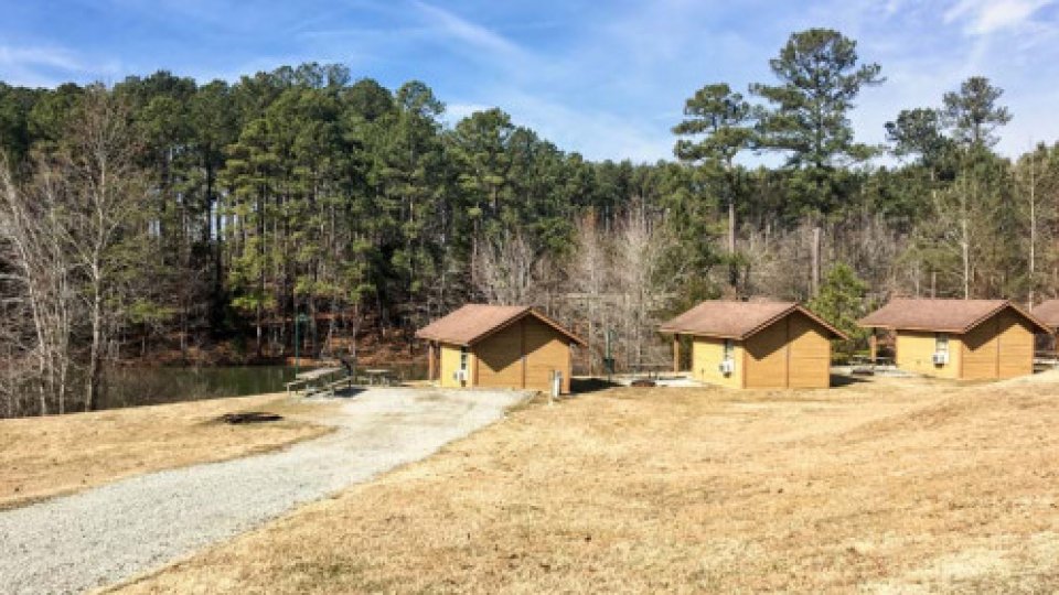 exterior of multiple cabins next to the lake
