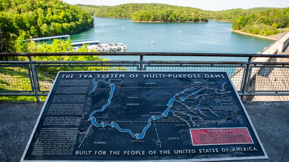 Map of TVA dams with lake and forested hills in the background.