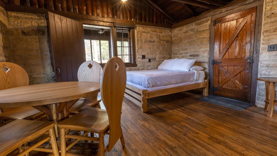 dining table, wooden floors in bedroom with large windows