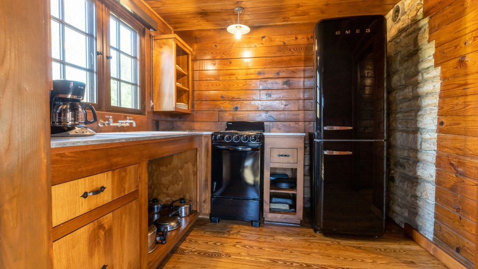 kitchen with large windows, vintage fridge, appliances and cabinets