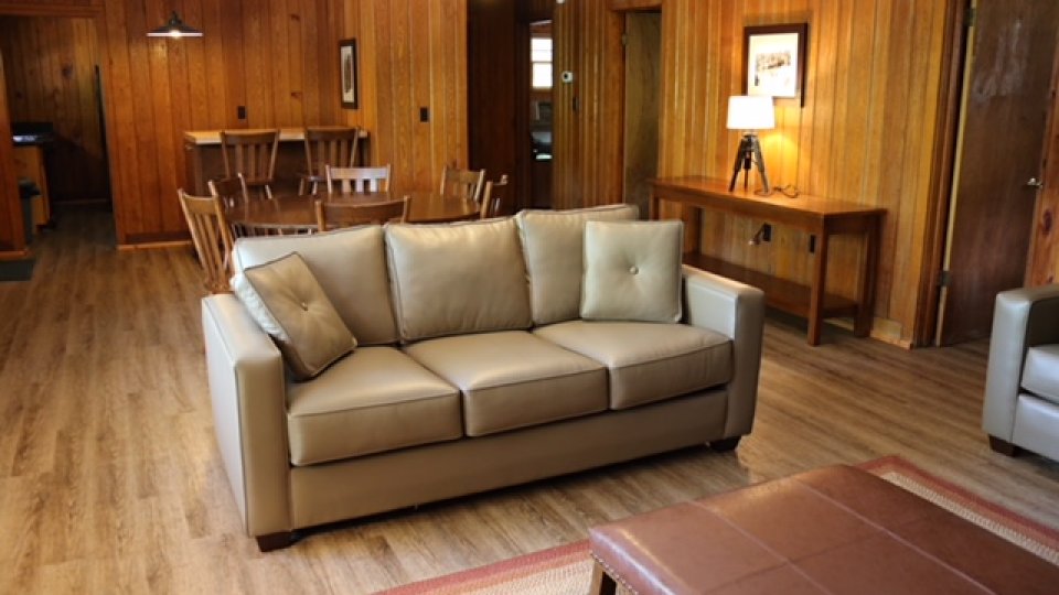 living room with hardwood floors, lamp, dining and coffee tables