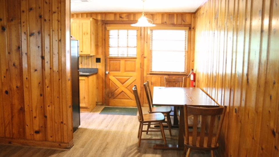 dining table by back entrance with overhead lighting and natural light