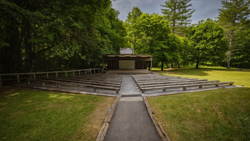Roan Mountain amphitheater with stone walls and wooden stage viewed from the front.