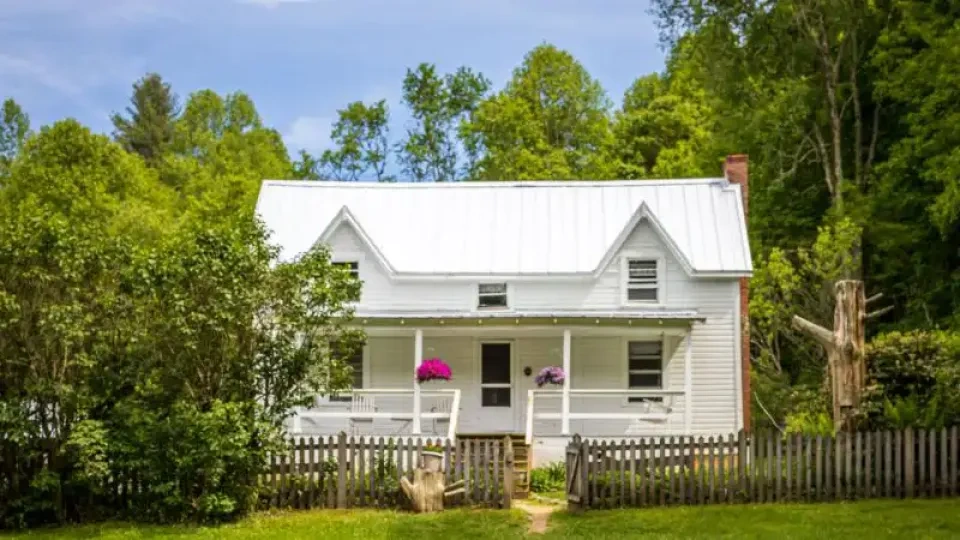 Another angle of Miller Farmstead with open grassy areas and surrounding forest.