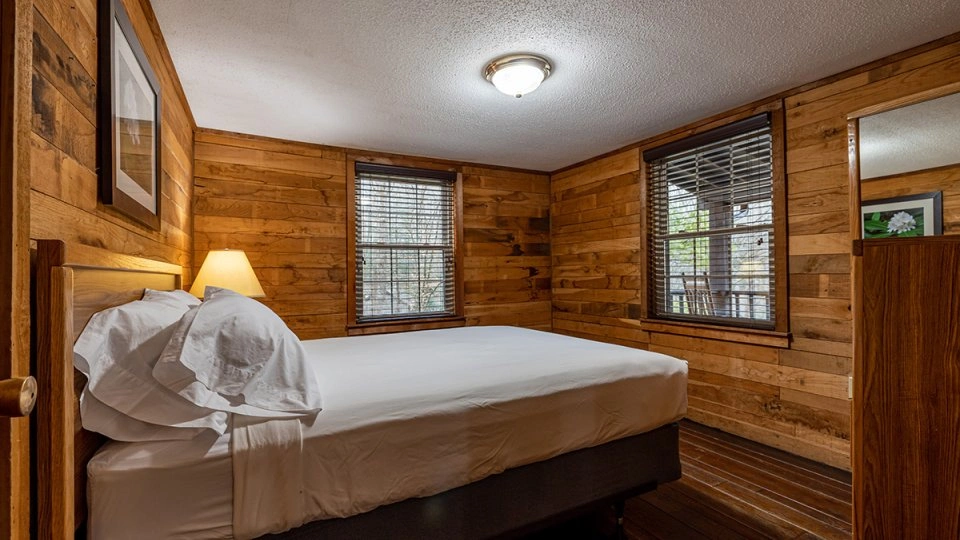 Alternate angle of the master bedroom showing additional furniture and decor.