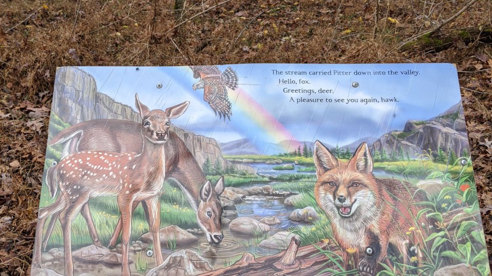 Bledsoe Creek Storybook Trail Sign with deer and fox illustrated telling a story