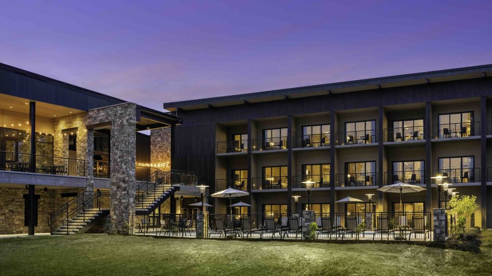 view of lodge at night with lights turned on