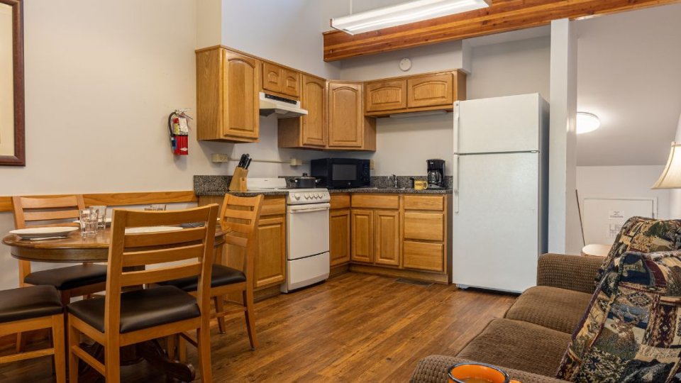 Cozy studio apartment interior with kitchen, dining area, and living space.