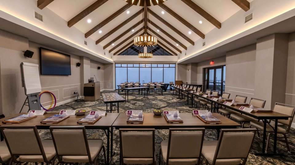Conference room setup with chairs, tables, and presentation equipment.