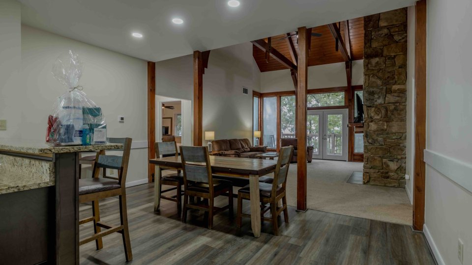 Spacious, modern living room with dining area and elegant wood accents.