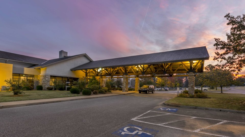 entrance of building with a large overhang and handicapped parking.
