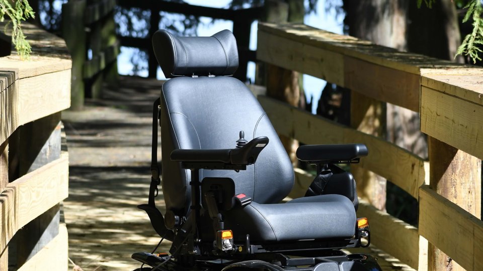 All terrain wheelchair on a wooden walkway.