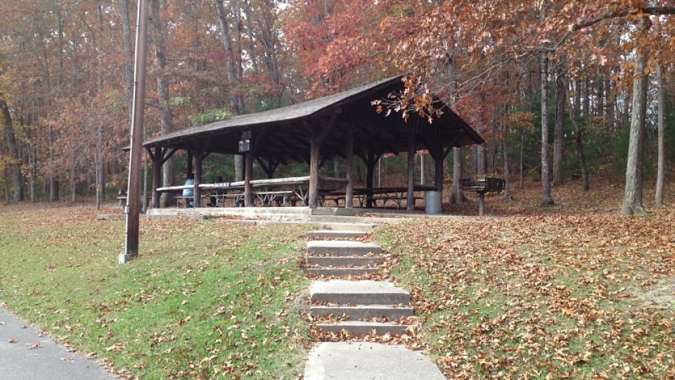 A set of stone steps leading to a wooden pavilion with picnic tables at Cumberland Mountain