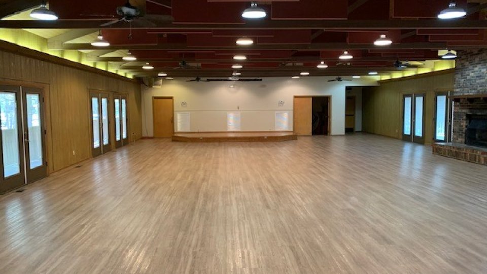 Spacious dance studio with wooden floors and mirrored walls
