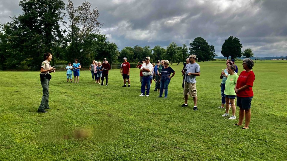 Group of people attending an outdoor event on a cloudy day.