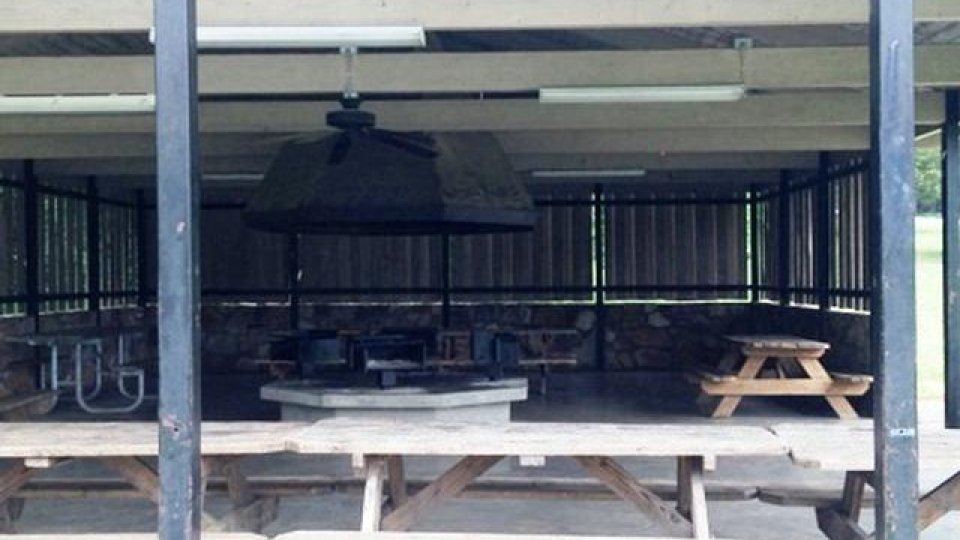 Covered pavilion with picnic tables and benches.