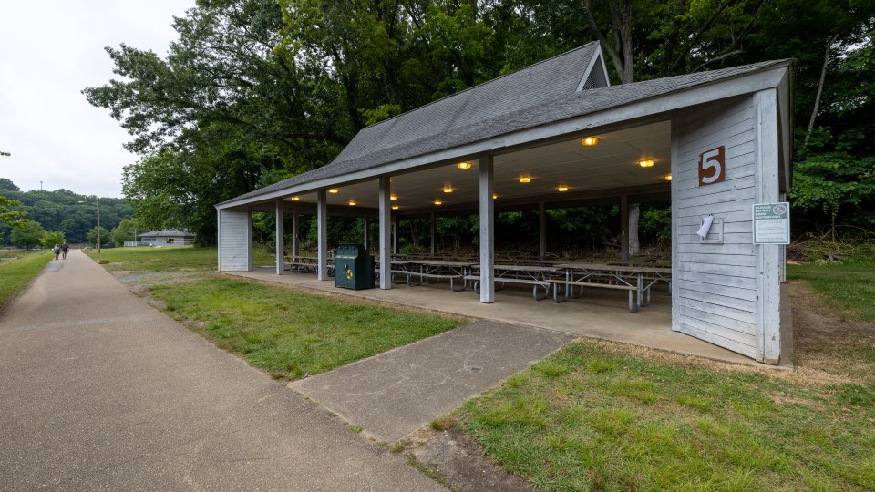 Pavilion Shelter #5 at Warriors' Path State Park along a pathway, overhead lights and picnic tables visible