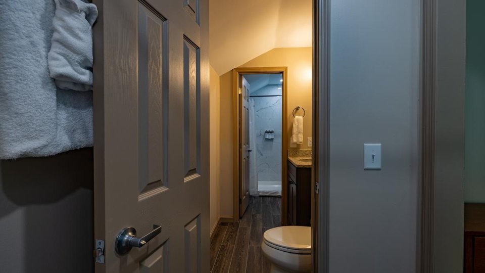 An open bathroom doorway in the cabin. A soft light is on in the bathroom.